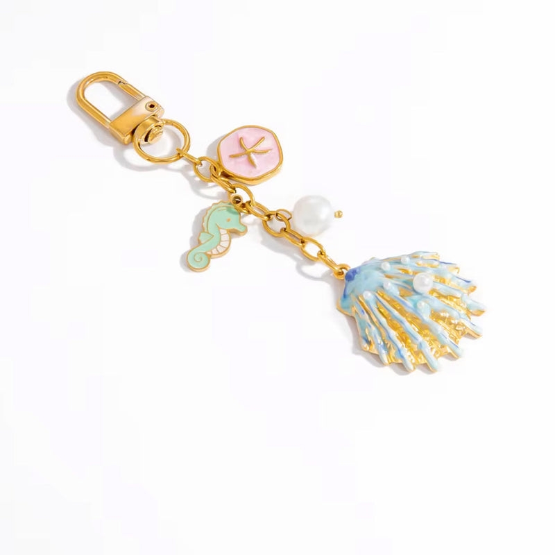 Gold plated coastal bag charm keychain with enamel seahorse blue seashell pearl and pink starfish coin charm