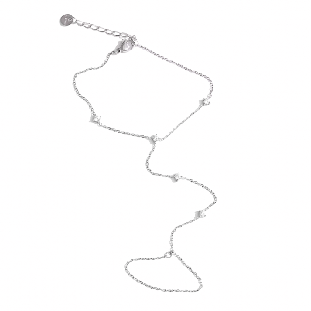 Silver hand chain with small pendants on a white background