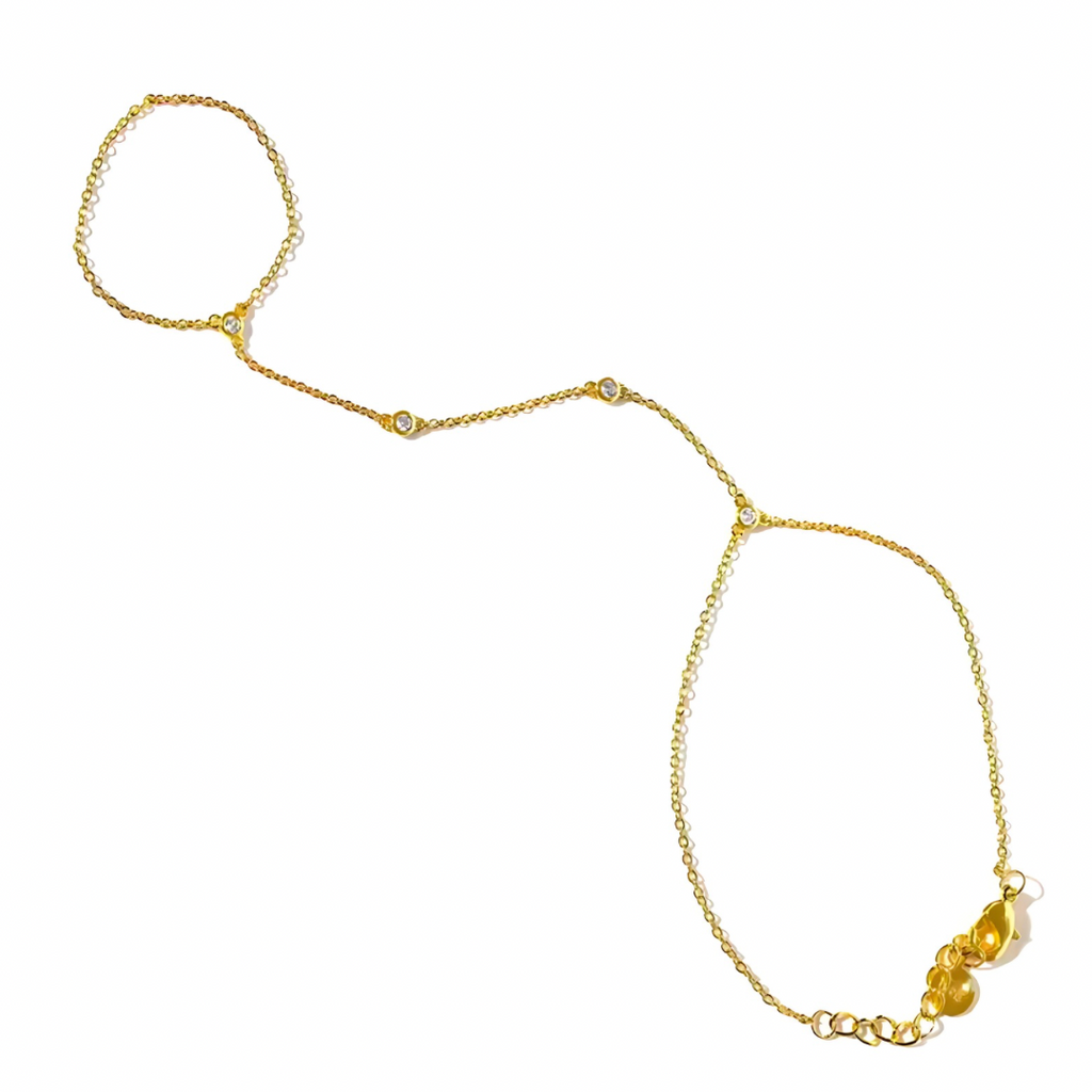 Gold hand chain with rhinestones on a white background