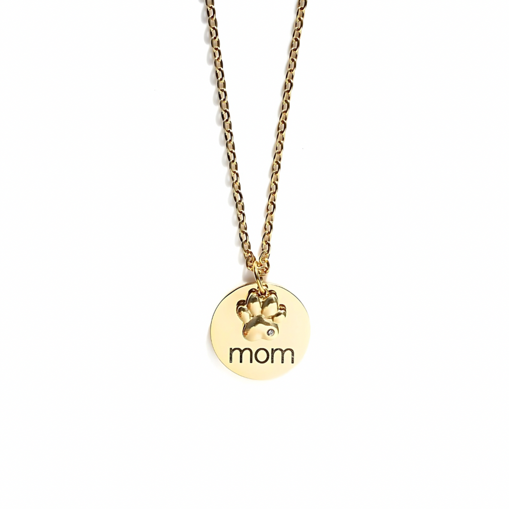 Gold necklace with 'mom' pendant on a white background
