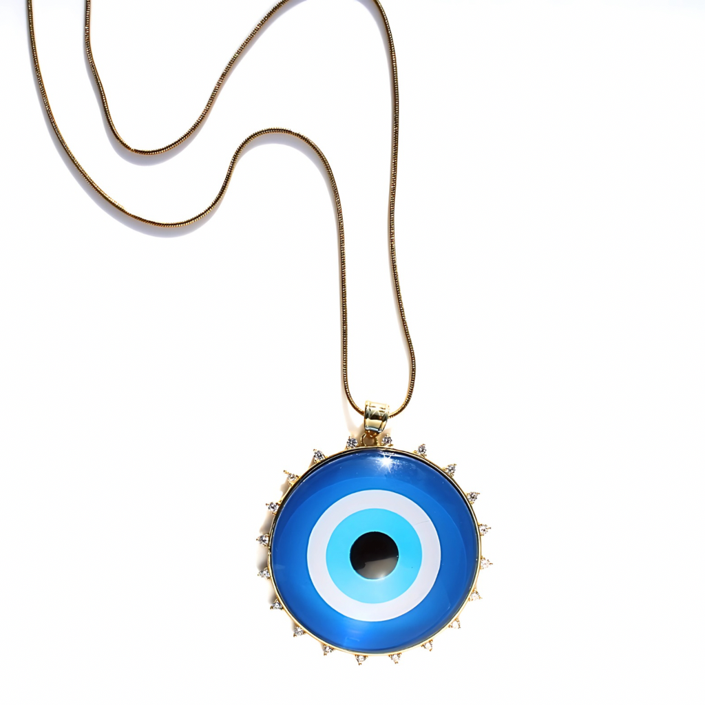 Blue evil eye pendant on a gold chain against a white background