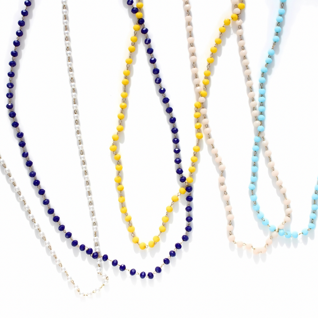 Set of beaded necklaces in various colors on a white background