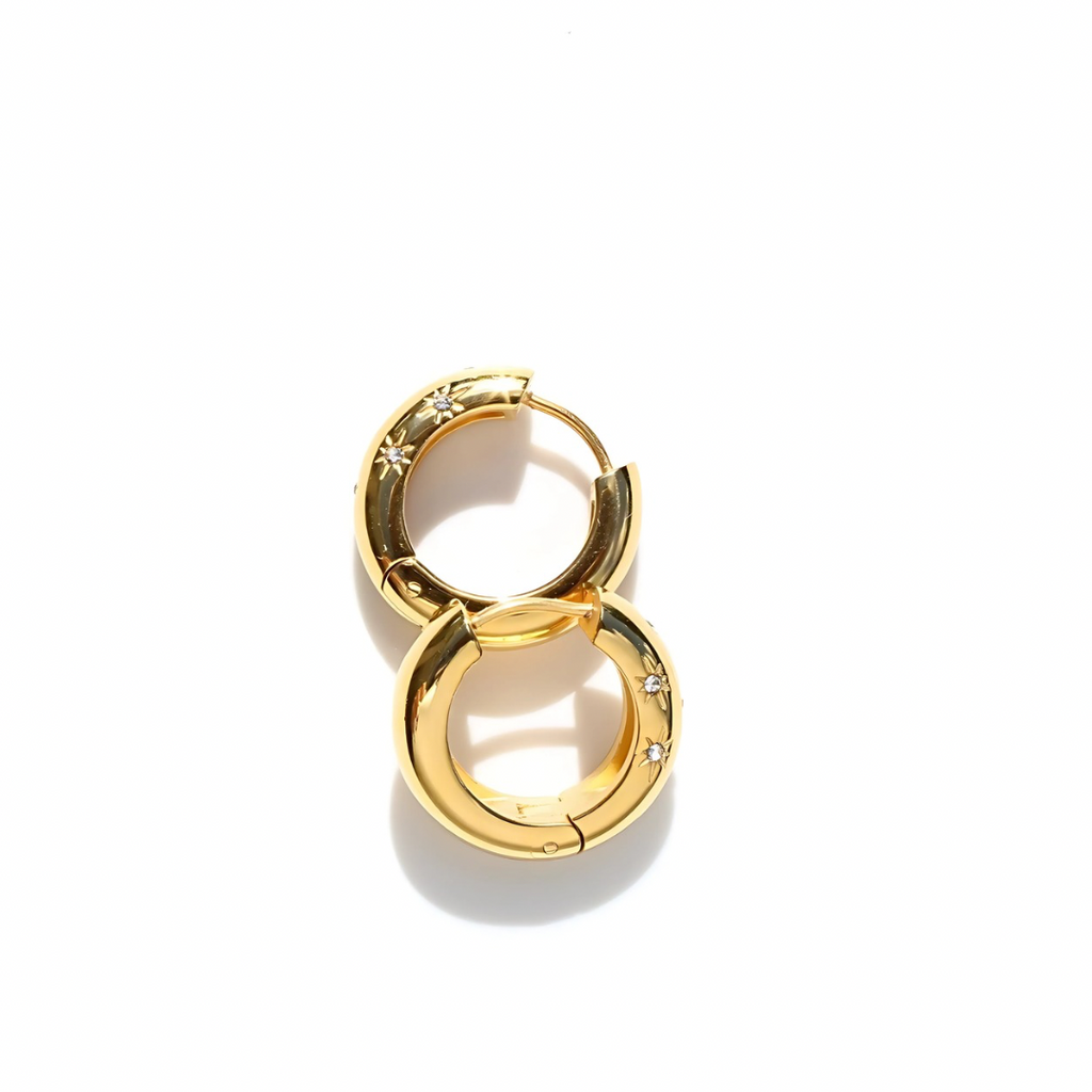 Gold hoop earrings with star designs on a white background