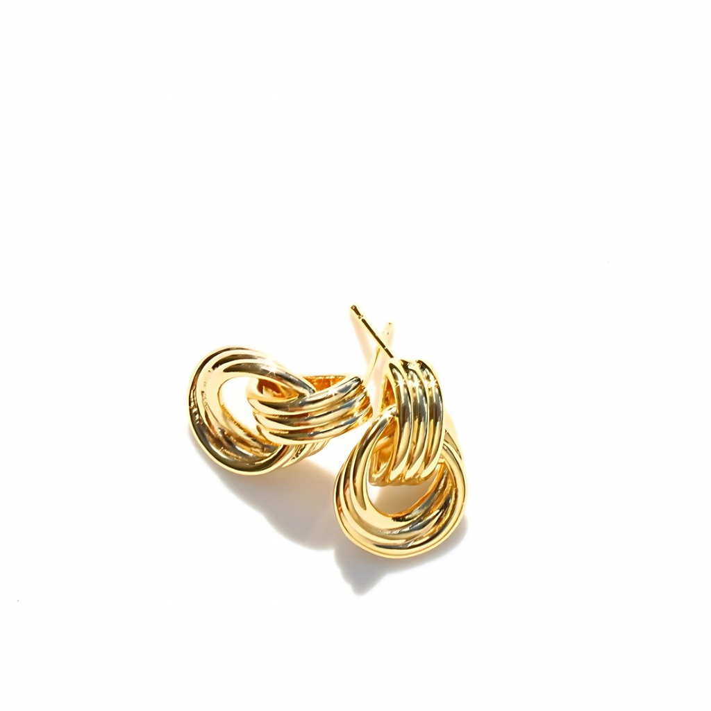 Gold stud earrings on a white background