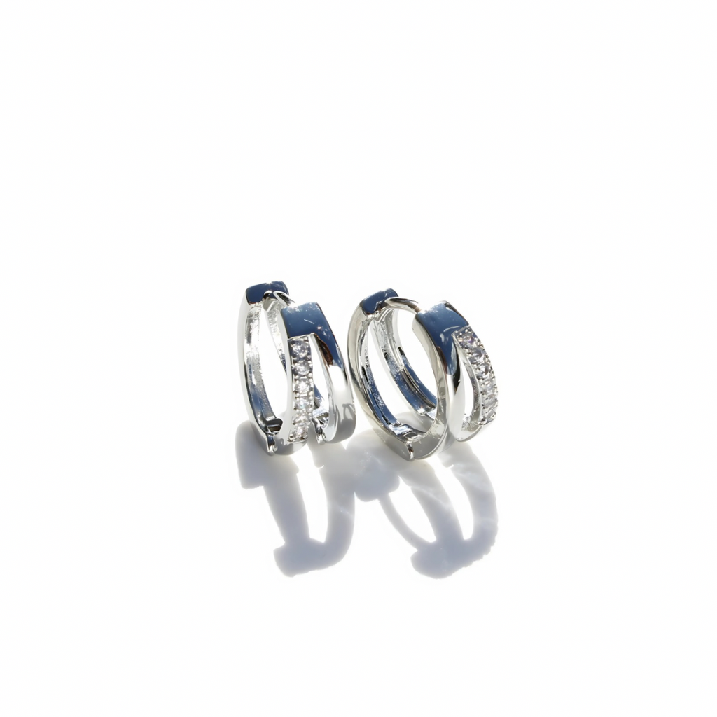 Pair of silver hoop earrings with white accents on a white background