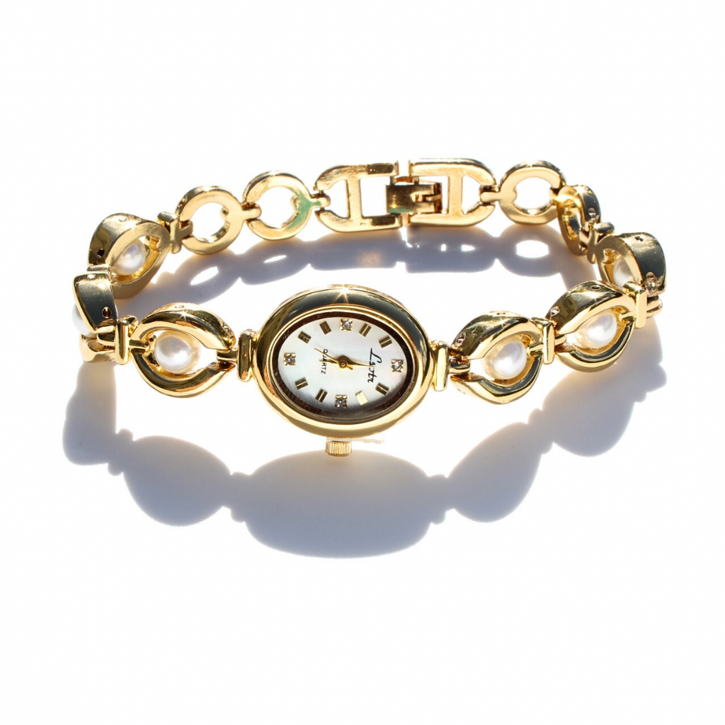 Gold chain watch with pearls on a white background