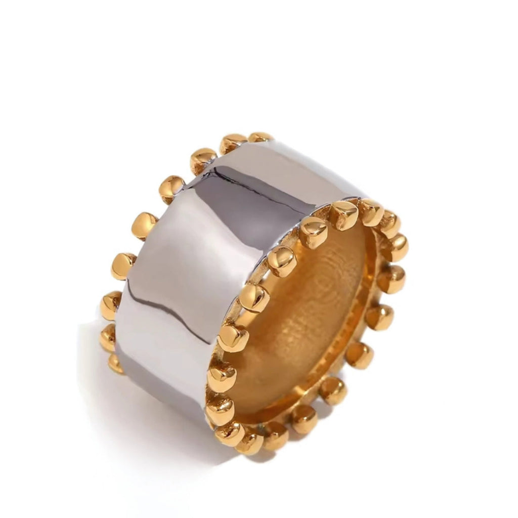 Two-tone ring with gold and silver design on a white background