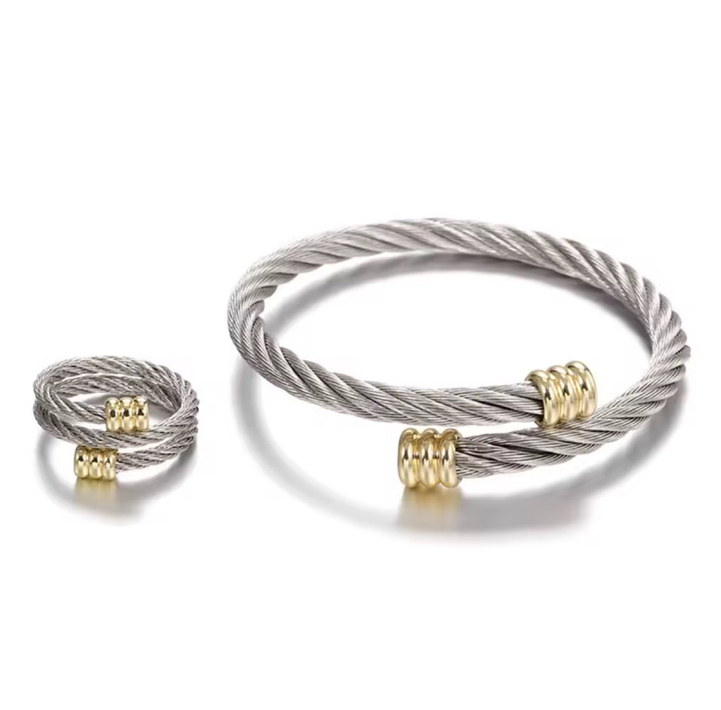 Silver and gold cable bracelets on a white background