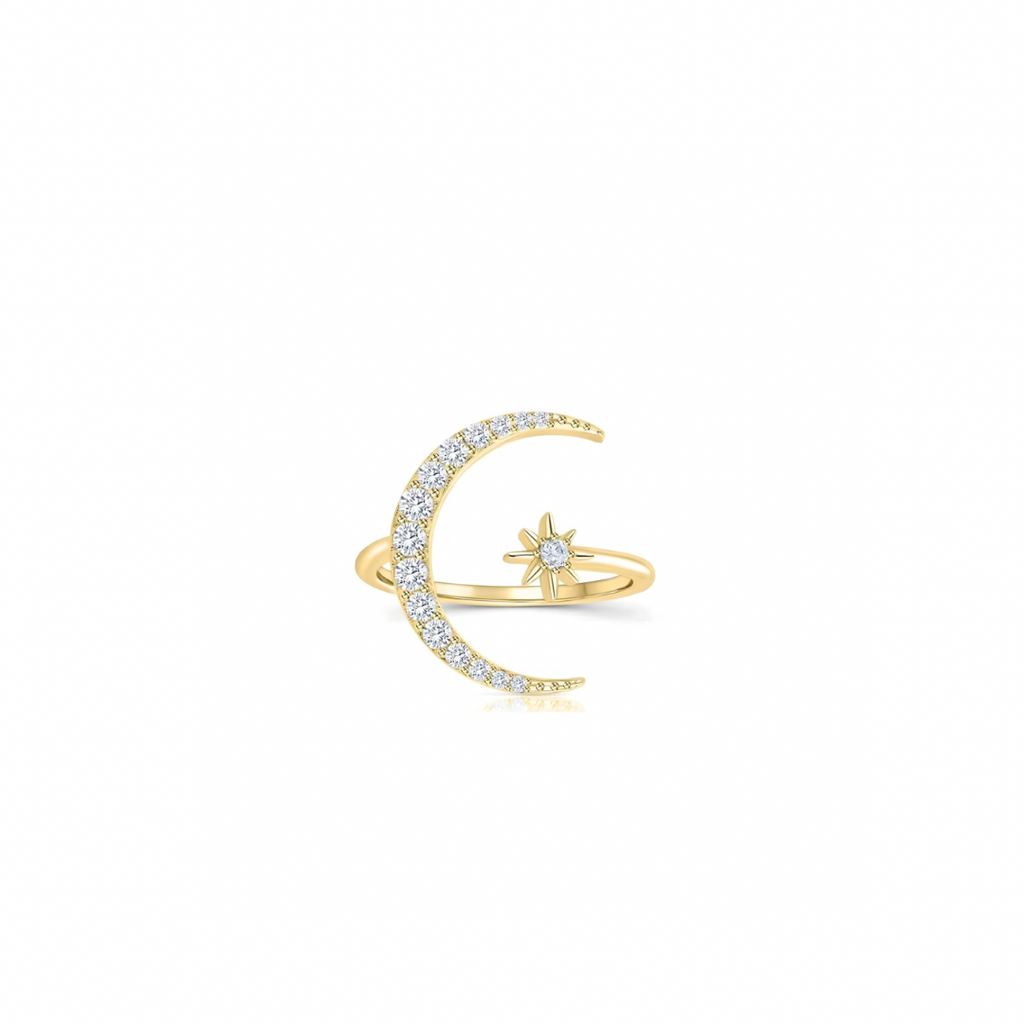 Gold ring with moon and star design on a white background
